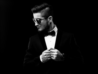 Portrait of handsome stylish man in elegant black suit