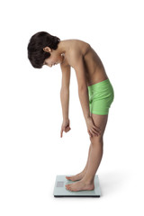 Eight year old boy on a weighing scale