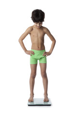 Eight year old boy on a weighing scale