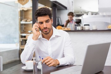 Man using mobile phone in coffee shop