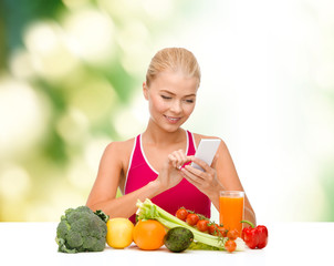 woman with vegetables pointing at smartphone