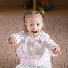 Fototapeta premium Little positive girl with Down syndrome