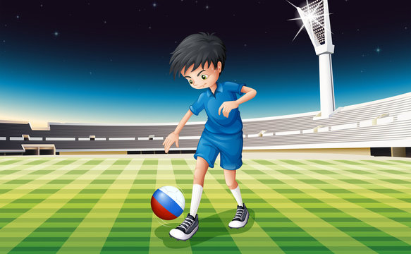 A boy at the field using the ball with the flag of Netherlands