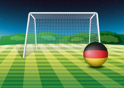 A soccer ball near the net with the flag of Germany