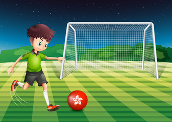 Fototapeta premium A young man kicking the ball with the flag of Hongkong