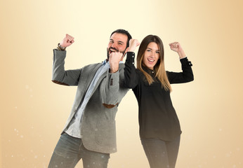 Couple winner over ocher background