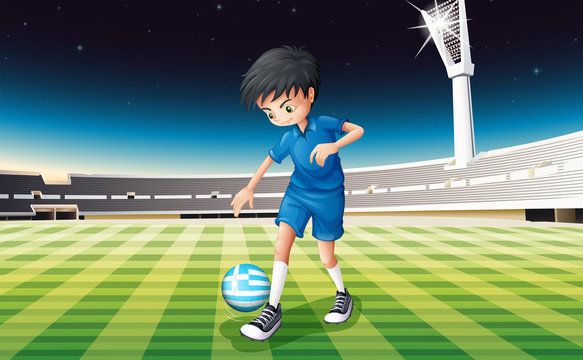 A boy at the field using the ball from Greece