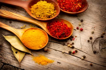 Various spices and herbs over wooden background