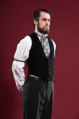 Retro 1900 victorian fashion man with beard wearing black gilet