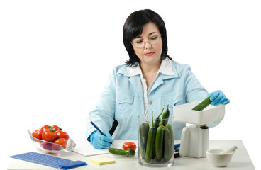 Phytosanitary technician weighing cucumber