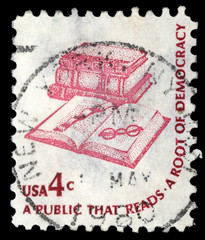 Stamp printed in USA, shows a book, bookmarks and glasses
