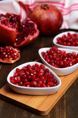 Ripe pomegranates on table close-up