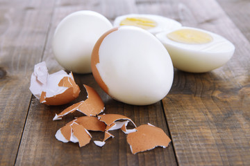 Peeled boiled egg on wooden background