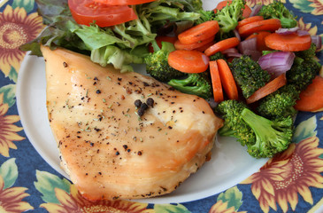 Grilled chicken breast with vegetables and salad