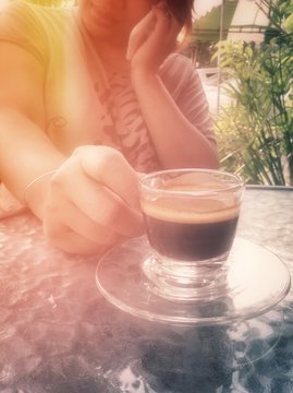 woman drink tea and using her cell phone in restaurant