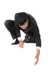 Asian businessman sit and bend down to help somebody