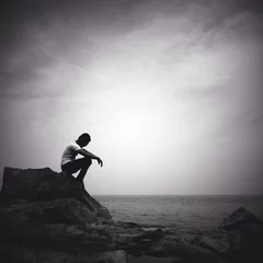 Foto op Canvas man sitting alone on the beach © nasruleffendy