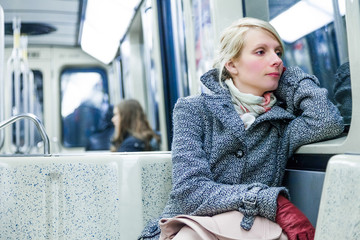 Young Woman Sitting inside a Metro Wagon