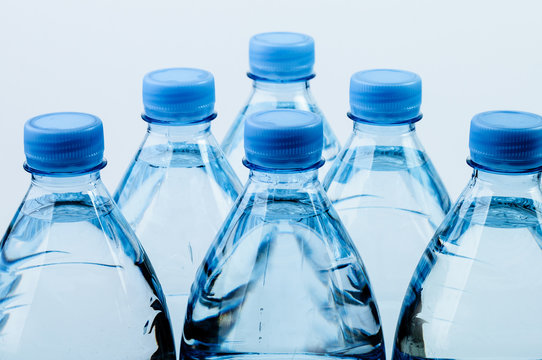 Six plastic bottles with water