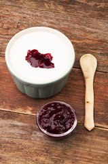 A bowl of cream and fruit jam