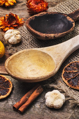 Two different wooden spoons and aroma ingredients