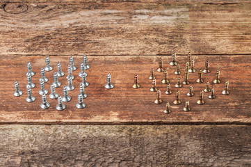 Two groups of different color screws on the table