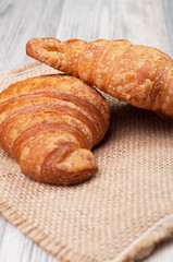 Two croissants on a linen cloth