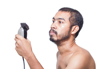 Naklejka premium Asian man seriously hold hair clipper