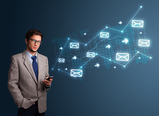 Young man holding a phone with arrows and message icons
