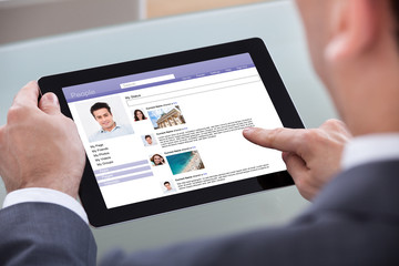 Fototapeta premium Close-up Of Man Browsing On Digital Tablet