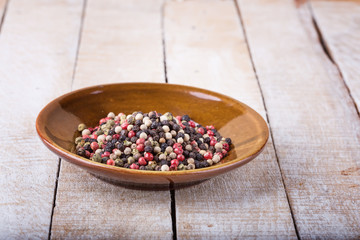 Mixed pepper on wooden background
