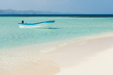 Boat moored in sea at beach