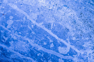 Rough surface closeup background in colored spots.