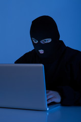 Criminal Using Laptop To Hack Online Account