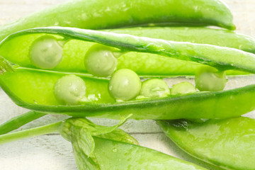 green peas over white wood
