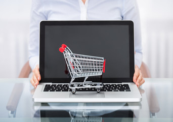 Businessperson With Shopping Cart And Laptop