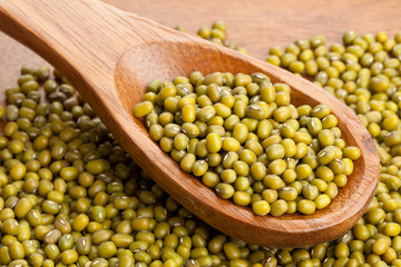 Raw mung beans on spoon