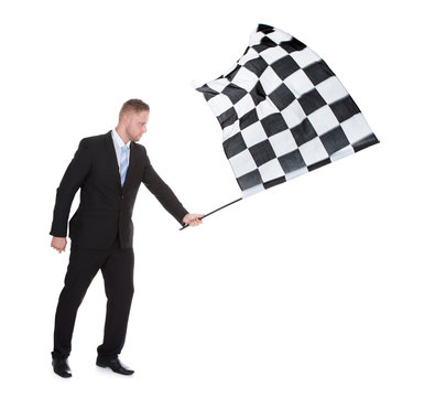 Conceptual image of a stylish young businessman waving a flag