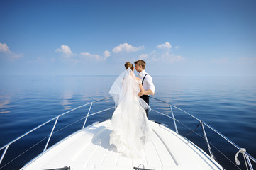 Happy bride and groom on a yacht