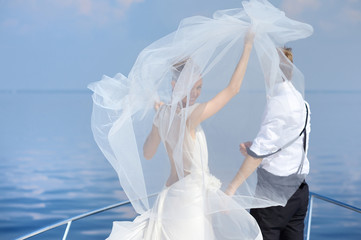 Happy bride and groom on a yacht