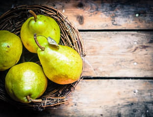 Pears on rustic wooden background