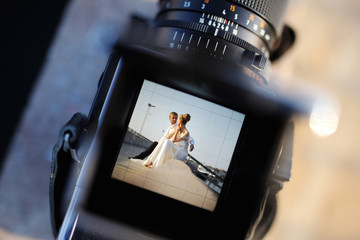 Shooting a wedding with a vintage camera - obrazy, fototapety, plakaty