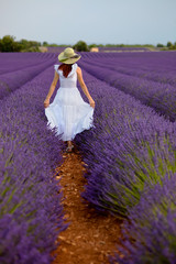 Beautiful woman in field of lavender in Provence, France.