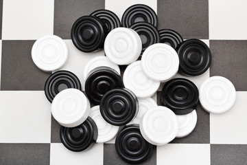 pile of checkers on checkerboard