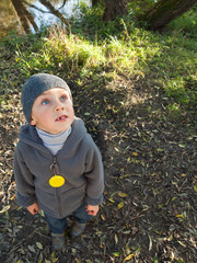 Lonely child looking up on a leaf background