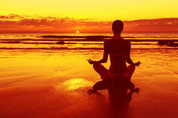 Fototapeta na wymiar Meditation on the beach at sunset
