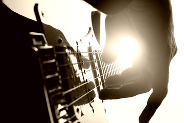 Guitarist plays on stage. Closeup view