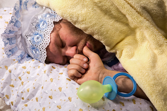 Man weared as baby sleep sucking his thumb