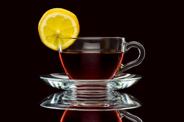 cup of tea and lemon on black background