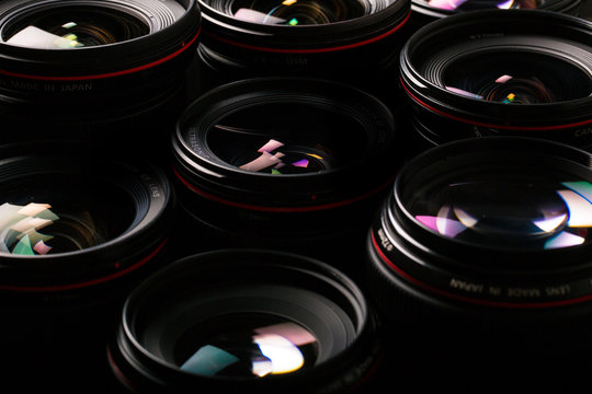 Modern camera lenses with reflections, low key image - Powered by Adobe
